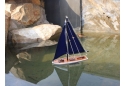 Wooden Floating Sailboat Blue Sails