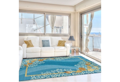 area rug features white coral with brown shells & sand dollars on a multi-colored blue wave like background.