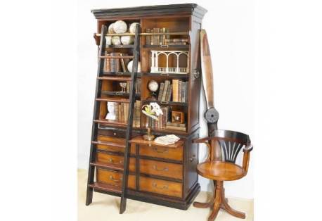 It features a striking library ladder, offers a multitude of large and small drawers, and is designed to fit in rooms large and small